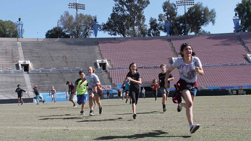 children running in Rose Bowl Stadium