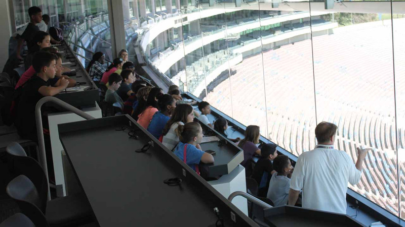 children looking down from the press box